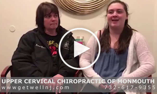 Two woman sitting next to each other in chairs as one speaks at Upper Cervical Chiropractic of Monmouth NJ