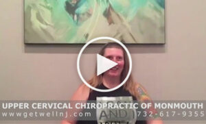 Woman smiling and sitting in room at Upper Cervical Chiropractic of Monmouth NJ