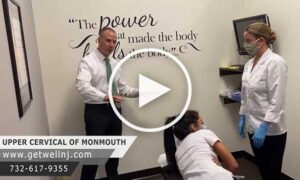 Doctors in room with patient lying down at Upper Cervical Chiropractic of Monmouth NJ